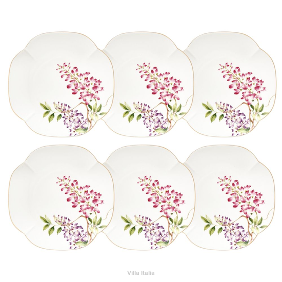 zestaw talerzyków do podawania ciasta ze złotymi zdobieniami z porcelany na stole