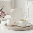 dzbanuszek do mleka, filiżanka i talerzyk deserowy z białej eleganckiej porcelany ze złotem