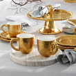 złote kubki porcelanowe do podawania gorących napojów na stół